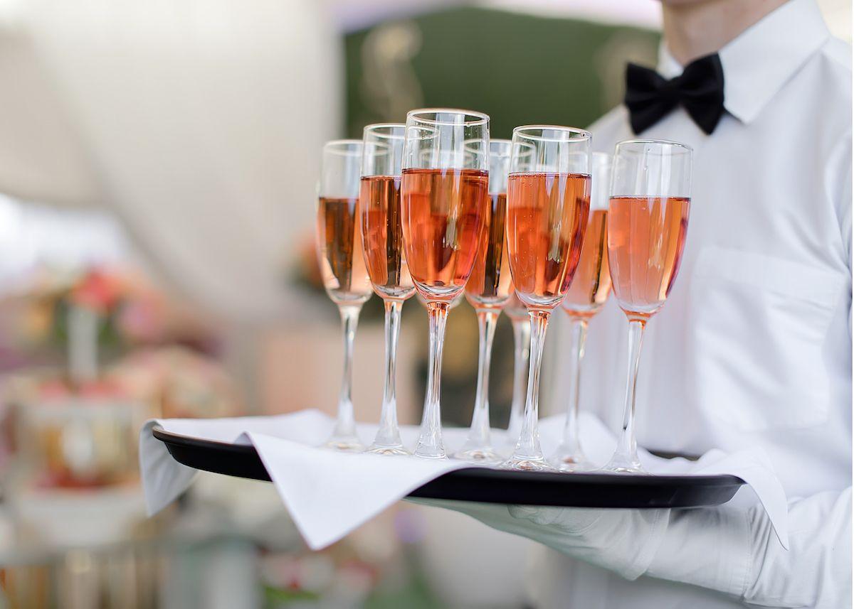 The Plaza Hotel Pioneer Park El Paso Exterior foto A waiter holding a tray of champagne